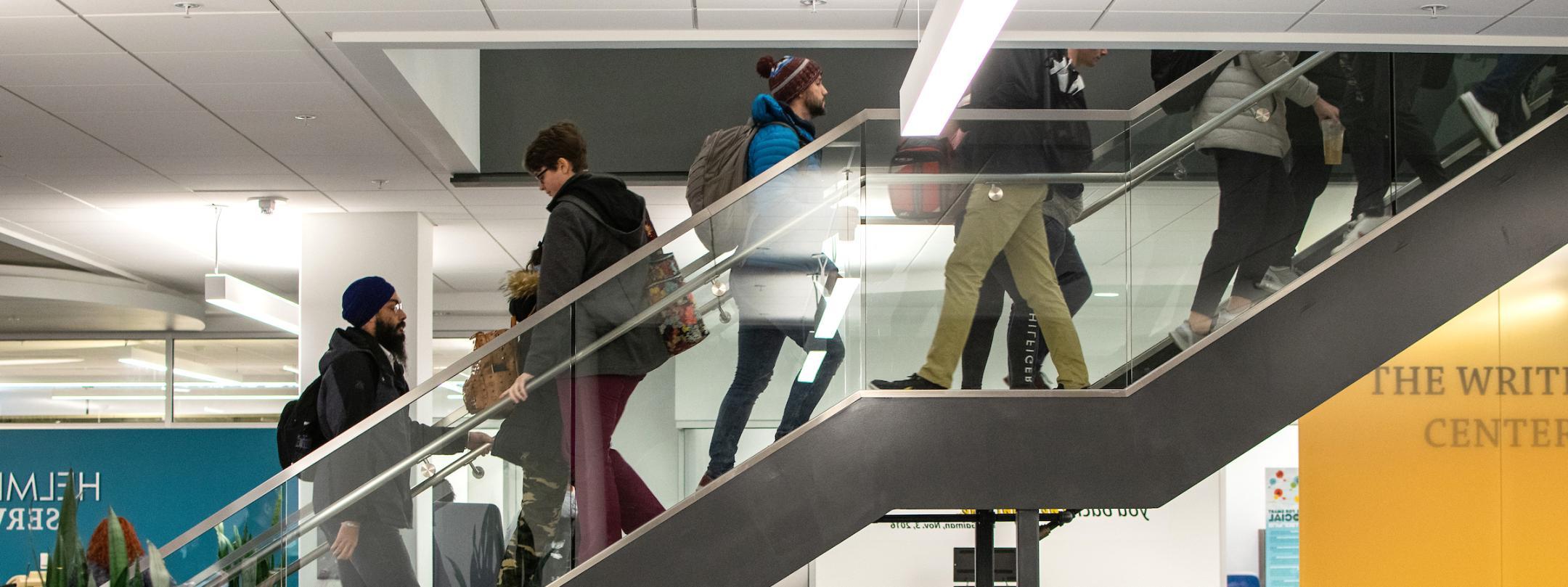 Students ascending and descending central library stairwell